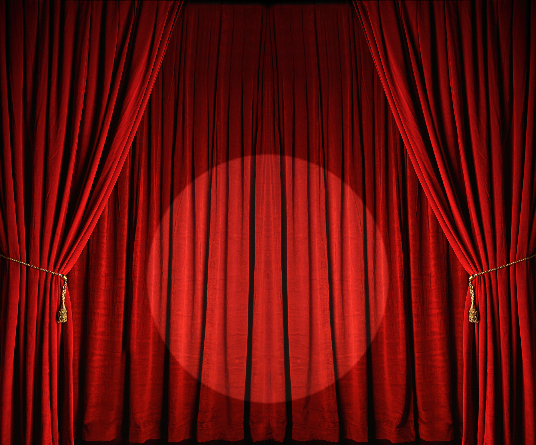 Large red theatre curtains with spotlight