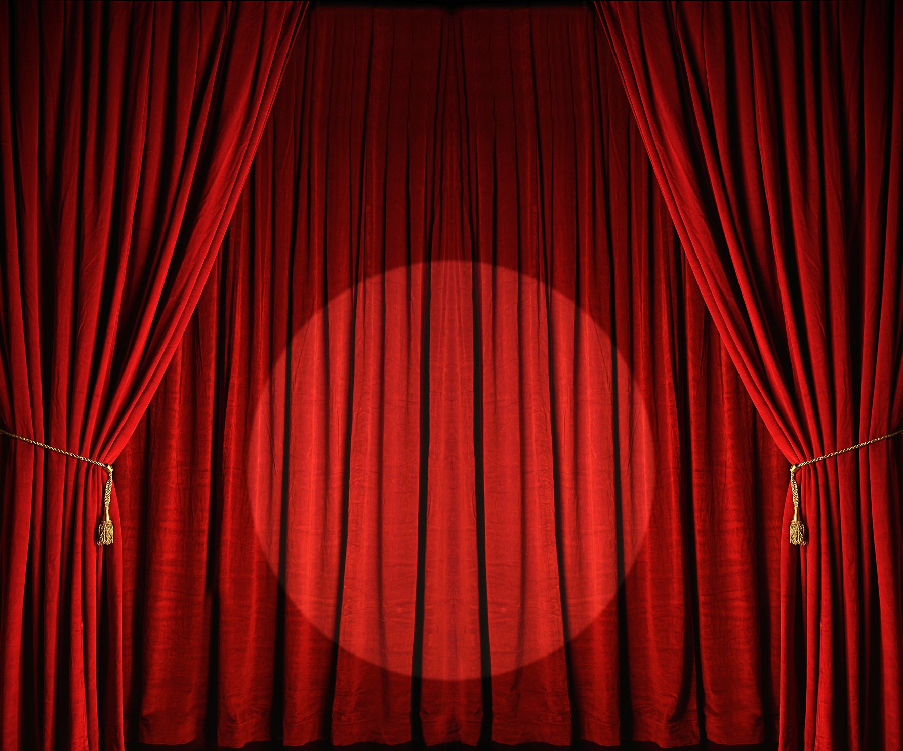 Large red theatre curtains with spotlight