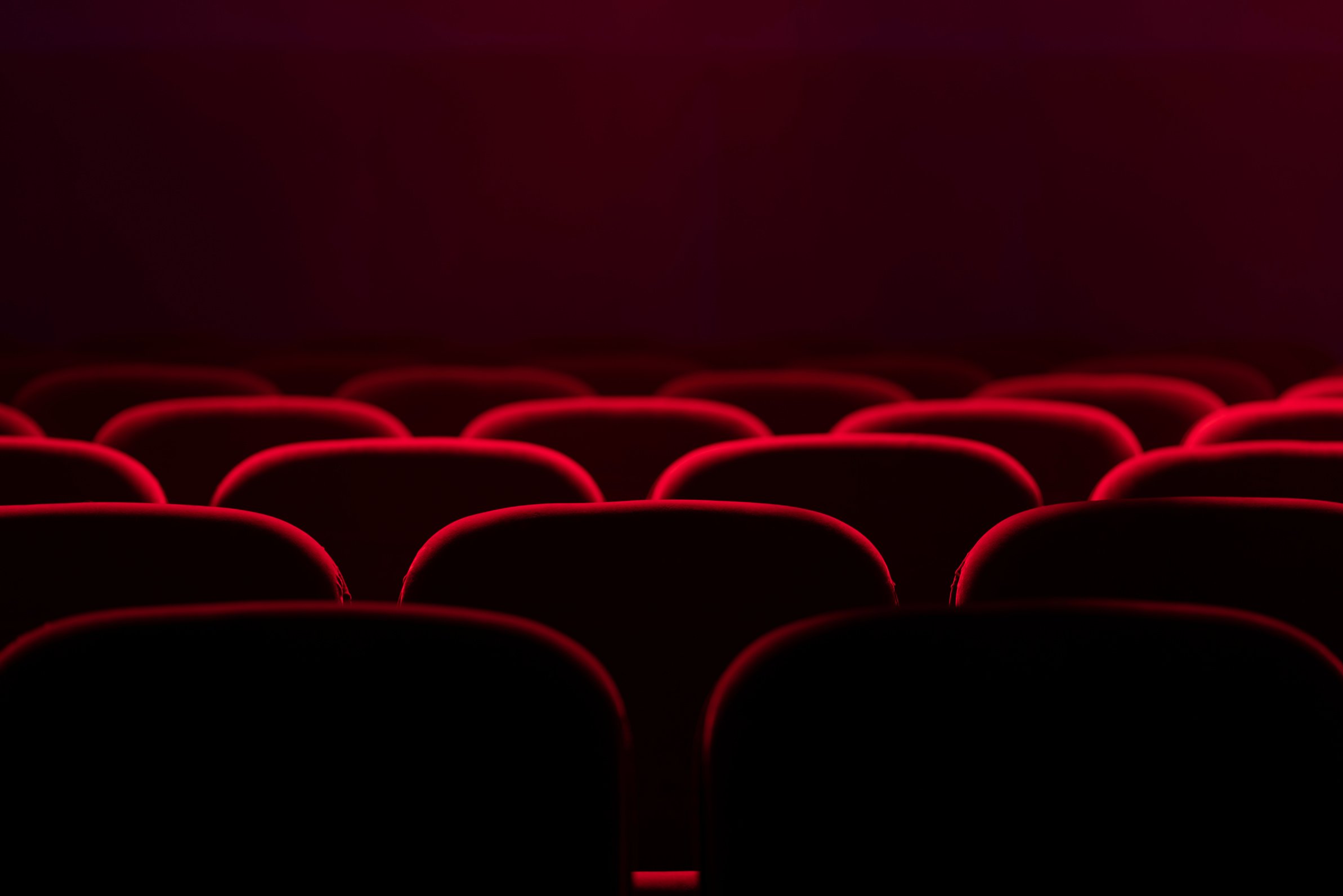 Empty cinema hall with red seats. Movie theatre