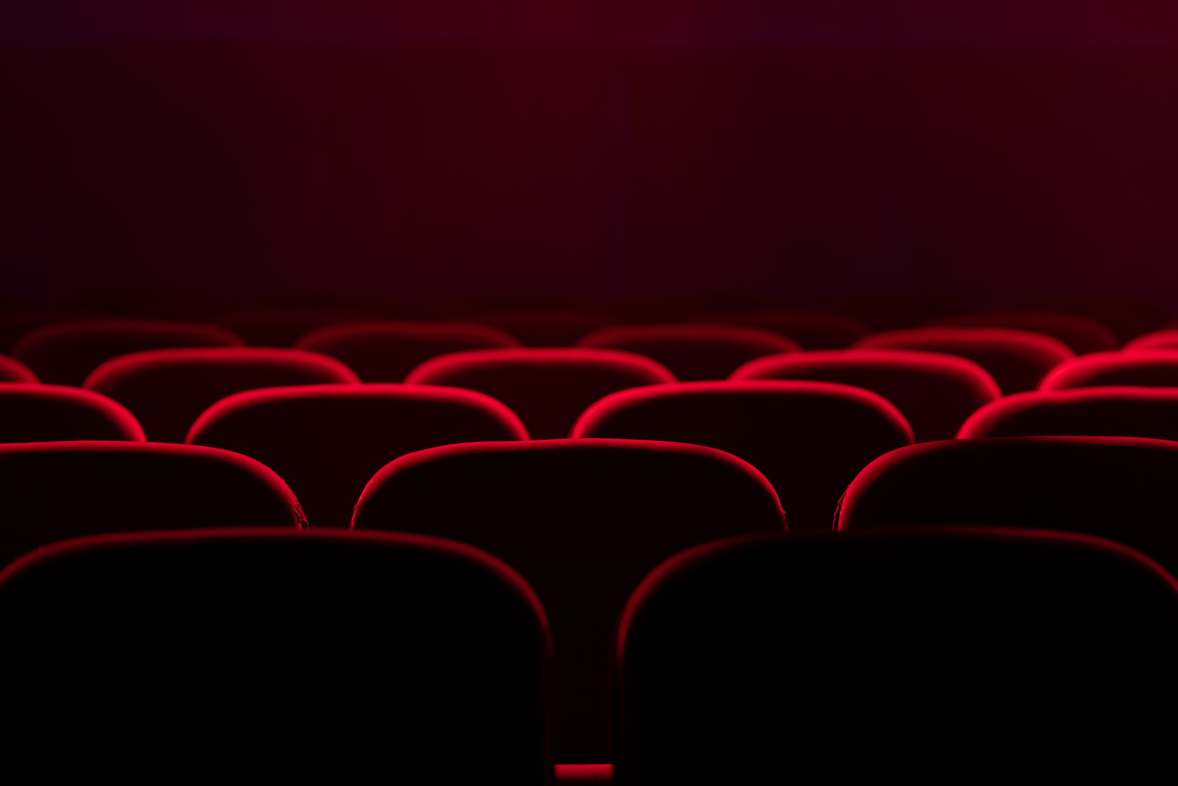 Empty cinema hall with red seats. Movie theatre